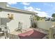 Relaxing patio with rocking chair, potted plants, and brick flooring at 27437 Desert Rose Ct, Leesburg, FL 34748