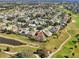 Aerial view of home in community near golf course and pond at 2876 Manor Downs, The Villages, FL 32162