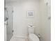 Bathroom with toilet, shower, and decorative art at 2876 Manor Downs, The Villages, FL 32162