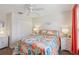 Bedroom with coral bedding and hardwood floors at 2876 Manor Downs, The Villages, FL 32162