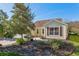 Side view of a house showcasing its landscaping and windows at 2876 Manor Downs, The Villages, FL 32162