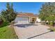 Front view of a charming house with a brick driveway at 2876 Manor Downs, The Villages, FL 32162