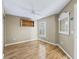 Bright bedroom featuring hardwood floors and built-in shelving at 3213 Archer Ave, The Villages, FL 32162