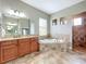 Bathroom boasts double vanity and a large soaking tub at 32801 Berwick Glen Ct, Sorrento, FL 32776