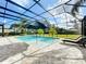 Relaxing pool and patio area with covered seating and landscaping at 32801 Berwick Glen Ct, Sorrento, FL 32776