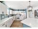 Modern kitchen with white cabinets, blue accents, and island at 3345 Atwell Ave, The Villages, FL 32162