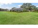 Large backyard with screened pool and lush landscaping at 5126 County Road 125, Wildwood, FL 34785