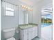 Bathroom with single sink vanity and pool view at 5126 County Road 125, Wildwood, FL 34785