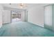 Bedroom with carpet, door to patio, and pool view at 5126 County Road 125, Wildwood, FL 34785