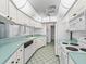 White kitchen with light green countertops and appliances at 5126 County Road 125, Wildwood, FL 34785