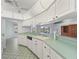 Kitchen with white cabinets, light green countertops, and tile floor at 5126 County Road 125, Wildwood, FL 34785