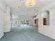 Bright living room with vaulted ceilings, carpet, and pool view at 5126 County Road 125, Wildwood, FL 34785