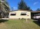 Single-wide manufactured home with carport and mature landscaping at 545 Jason Dr, Lady Lake, FL 32159