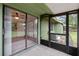 Bright screened porch with sliding glass doors leading to backyard at 636 Mount Homer Rd # 636, Eustis, FL 32726