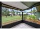 Screened porch overlooks a grassy backyard and neighboring homes at 636 Mount Homer Rd # 636, Eustis, FL 32726