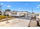 Front view of a white manufactured home with a carport and landscaping at 638 Rainbow Blvd, Lady Lake, FL 32159