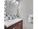 Modern bathroom with patterned wallpaper and updated vanity at 6607 Crestmont Glen, Windermere, FL 34786