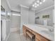 Bathroom with a bathtub, vanity, and large mirror at 6607 Crestmont Glen, Windermere, FL 34786