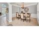Elegant dining room with chandelier and seating for six at 6607 Crestmont Glen, Windermere, FL 34786