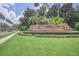Community entrance with landscaped lawn and signage at 6607 Crestmont Glen, Windermere, FL 34786
