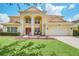 Two-story house with a large front yard, double doors, and a three-car garage at 6607 Crestmont Glen, Windermere, FL 34786