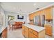 Eat-in kitchen with island, wood cabinets, and stainless steel appliances at 6607 Crestmont Glen, Windermere, FL 34786