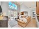 Spacious living room with high ceilings, tan couch, and pool view at 6607 Crestmont Glen, Windermere, FL 34786