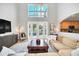 Two story living room with large windows and pool access at 6607 Crestmont Glen, Windermere, FL 34786