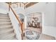 Elegant two-story entryway with a grand staircase, chandelier, and formal dining area at 6607 Crestmont Glen, Windermere, FL 34786