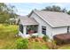 Rear view of house showing screened porch and landscaping at 87 Twin Lake Cir, Umatilla, FL 32784