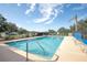 Community pool with lounge chairs and clear water at 87 Twin Lake Cir, Umatilla, FL 32784