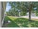 Large backyard with grassy area and mature trees at 9249 Ivywood St, Clermont, FL 34711