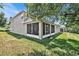 House exterior showcasing large backyard and screened porch at 9249 Ivywood St, Clermont, FL 34711