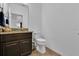 Small bathroom with granite countertop and dark cabinets at 9249 Ivywood St, Clermont, FL 34711