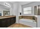 Elegant bathroom featuring a soaking tub and updated vanity at 9249 Ivywood St, Clermont, FL 34711
