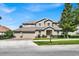 Two-story house with a three-car garage and landscaped yard at 9249 Ivywood St, Clermont, FL 34711