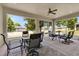Screened porch with table and chairs, overlooking backyard at 9249 Ivywood St, Clermont, FL 34711