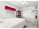 Bedroom with a metal bed frame, bookcase, and window with red valance at 9773 Se 175Th Ln, Summerfield, FL 34491