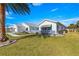 Ranch-style home with lush lawn and palm trees at 9773 Se 175Th Ln, Summerfield, FL 34491