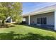 Landscaped backyard with screened porch and grassy area at 1018 Green Gate Blvd, Groveland, FL 34736