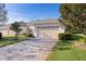 Exterior view of villa with attached garage and paver driveway at 1018 Green Gate Blvd, Groveland, FL 34736
