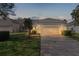 Evening view of villa with attached garage and paver driveway at 1018 Green Gate Blvd, Groveland, FL 34736