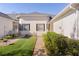 Front entry with walkway, landscaping, and two-car garage at 1018 Green Gate Blvd, Groveland, FL 34736