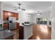 Open kitchen with island, stainless steel appliances, hardwood floors at 1018 Green Gate Blvd, Groveland, FL 34736