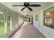 Bright screened porch with tile floors and large windows at 1210 Loch Rannoch Ct # 0, Leesburg, FL 34788