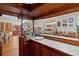 Home bar with wood finishes and tile counters at 1600 Se 52Nd St, Ocala, FL 34480