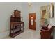 Entryway with wooden bench, antique cabinet, and tiled floor at 1600 Se 52Nd St, Ocala, FL 34480