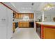 Galley kitchen with wood cabinets and modern appliances at 1600 Se 52Nd St, Ocala, FL 34480