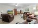 Living room with leather sofas, coffee table, and ceiling fan at 1600 Se 52Nd St, Ocala, FL 34480