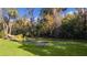 Serene backyard oasis featuring a pond and a wooden bench at 1600 Se 52Nd St, Ocala, FL 34480